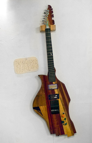 Simon's first guitar, with 18 types of wood, has accompanied him to Europe twice.